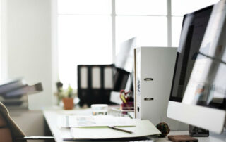 Computer and files on a desk in an office