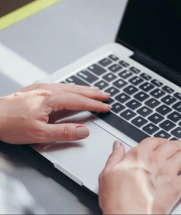 Person searching the internet Picture of 2 hands and a laptop